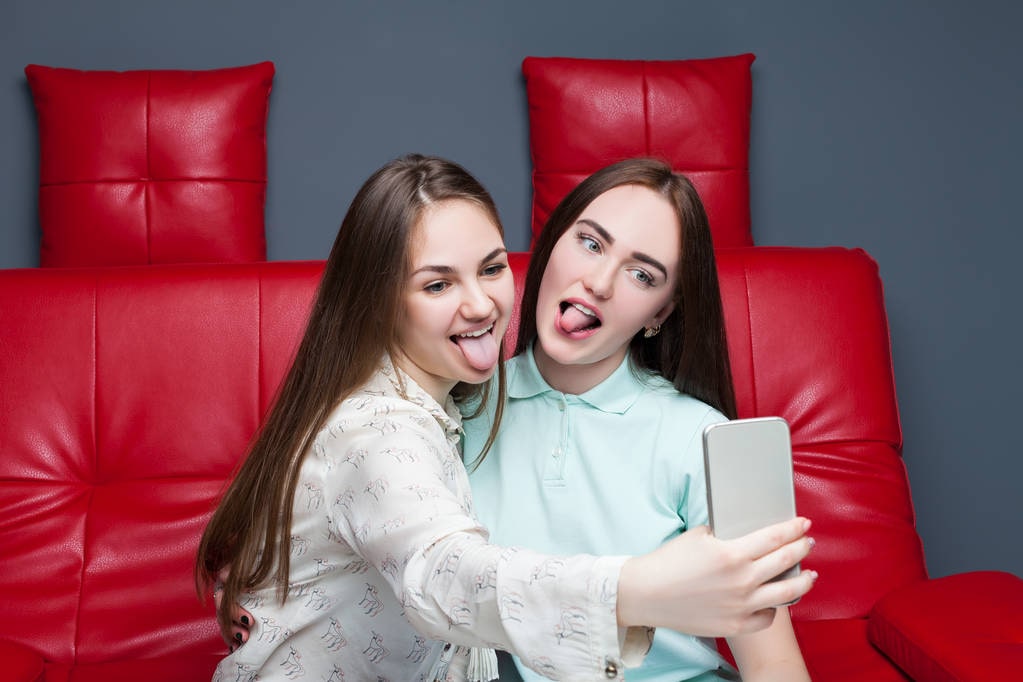 Two females showing healthy tongue