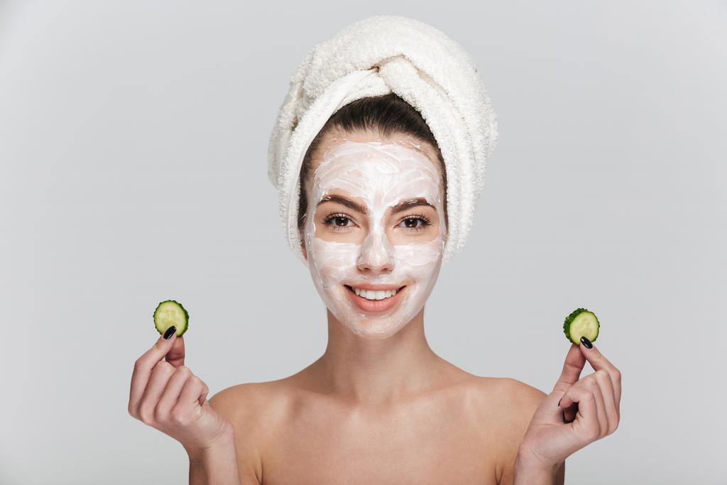 Young woman with facial skincare mask isolated on white