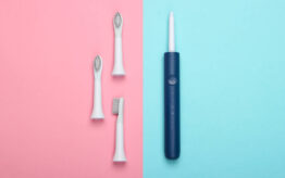 An electric toothbrush and three replacement brush heads.