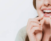 A woman wearing a clear aligner.